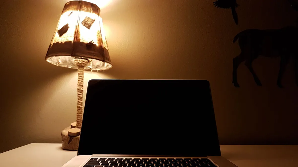 Late night laptop application for an online loan with a coffee on the desk