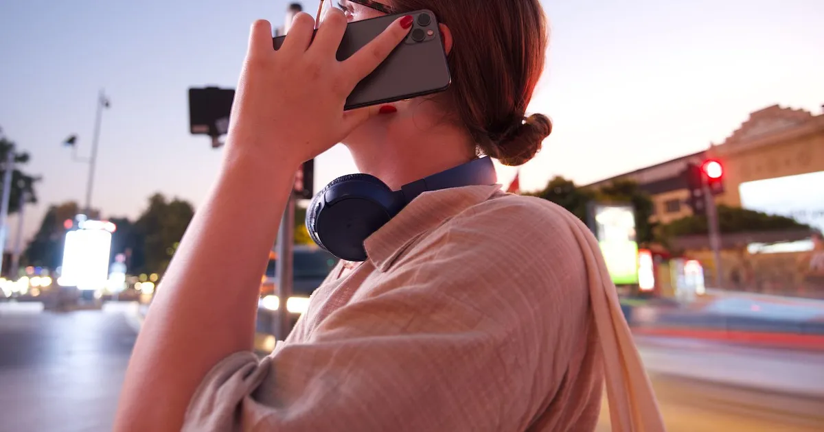 Phone lit up at night with a 24/7 instant loans approval notification over a city skyline
