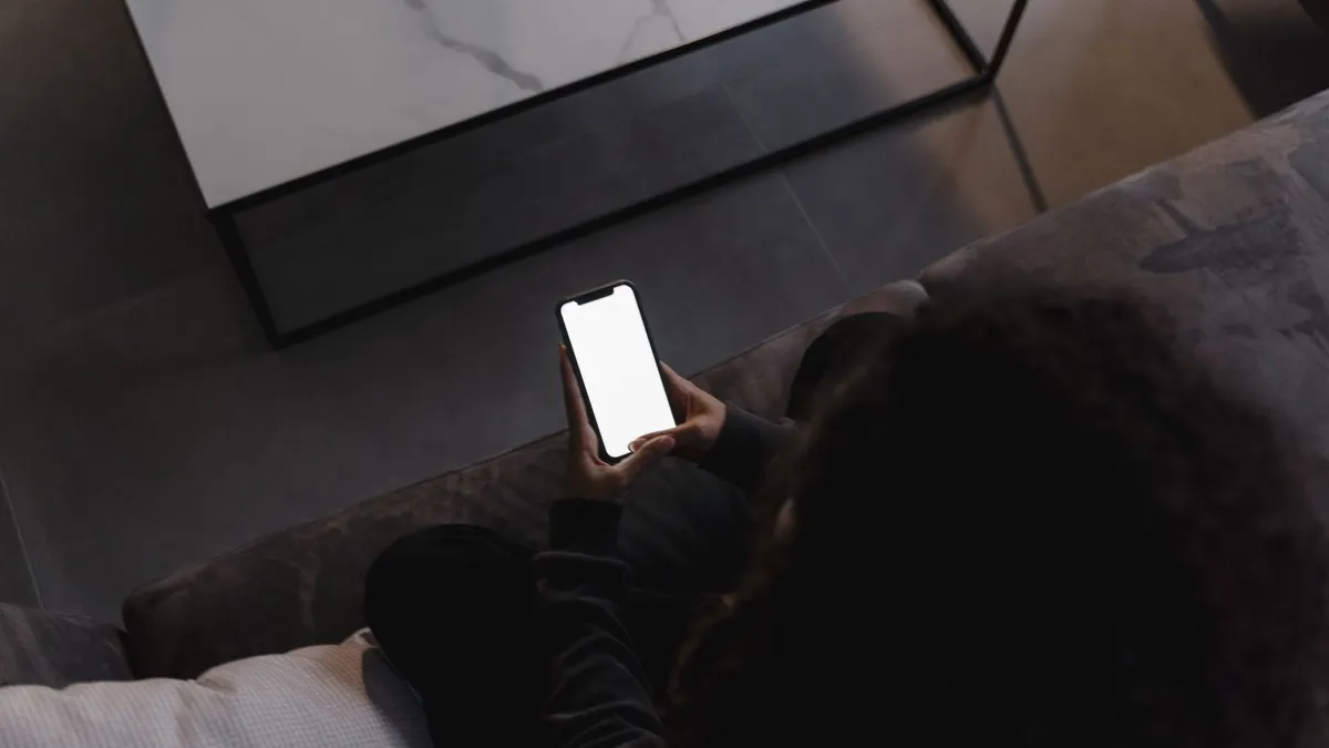 Borrower relaxing on a sofa after receiving an e-transfer from a paperless loan