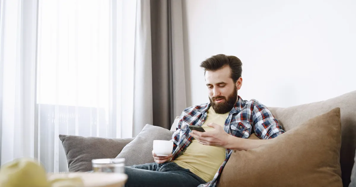 Person applying for instant cash loans no documents on a phone from the couch