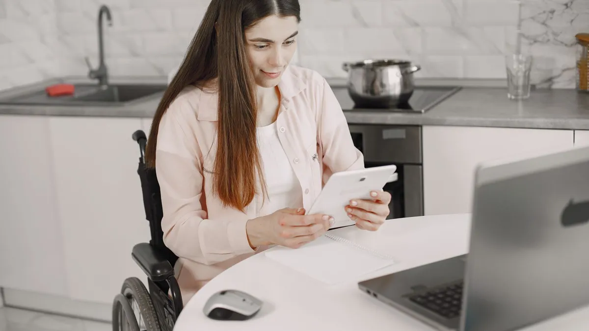 Accessible kitchen where a borrower checks an e-transfer deposit on a phone