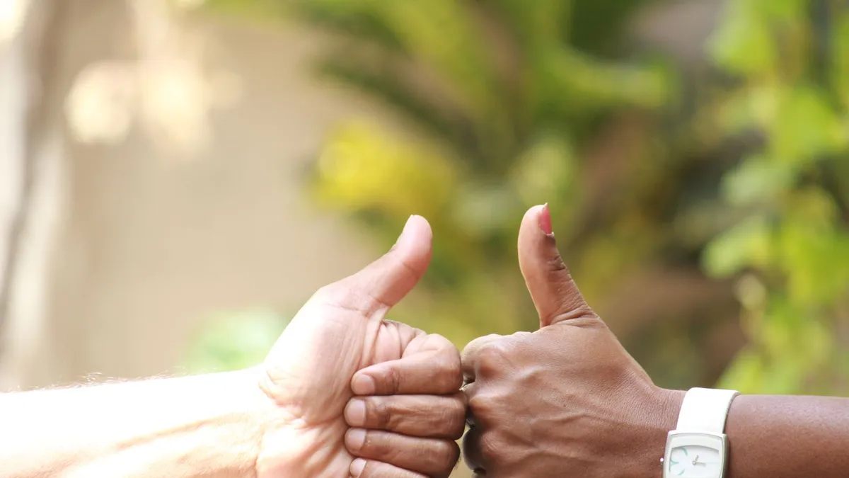 Hand holding a phone showing an approved loan notification and e-transfer alert